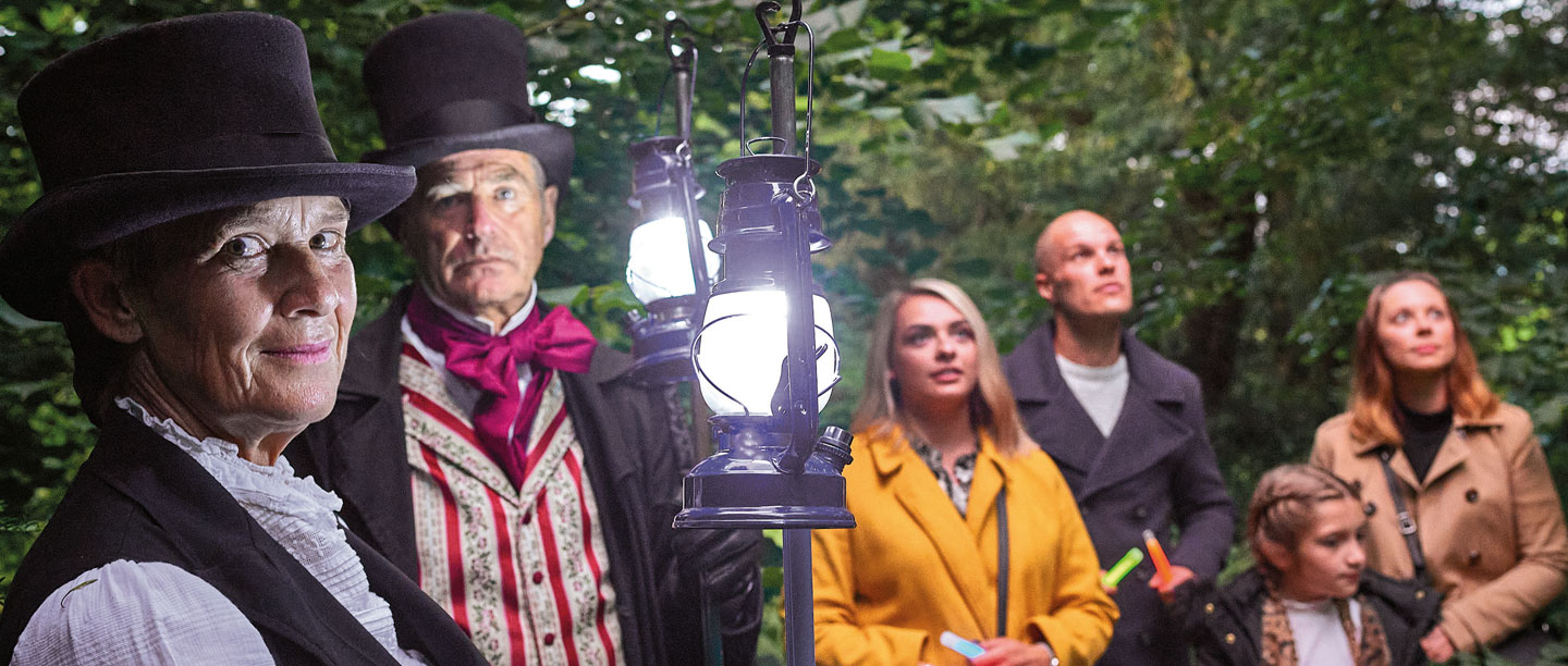 Image: Geoff Harris and Gayna Johnson with a family on a Spooky Walk