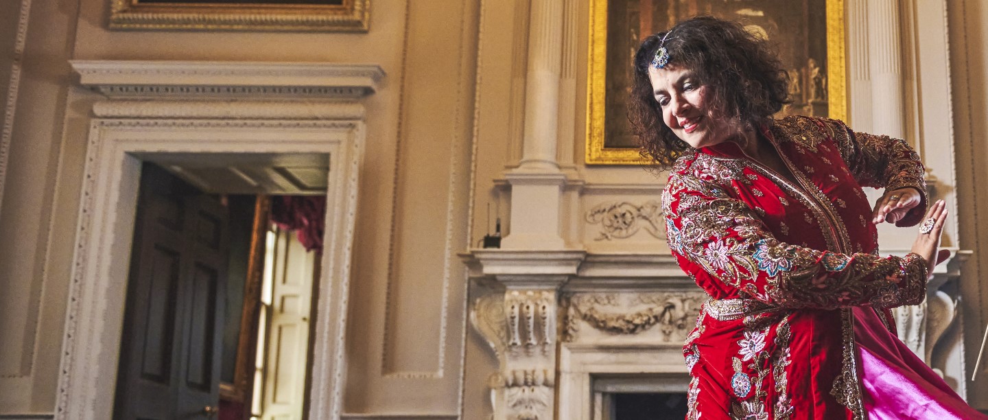 Image: A person in a red dress dances at Marble Hill in London