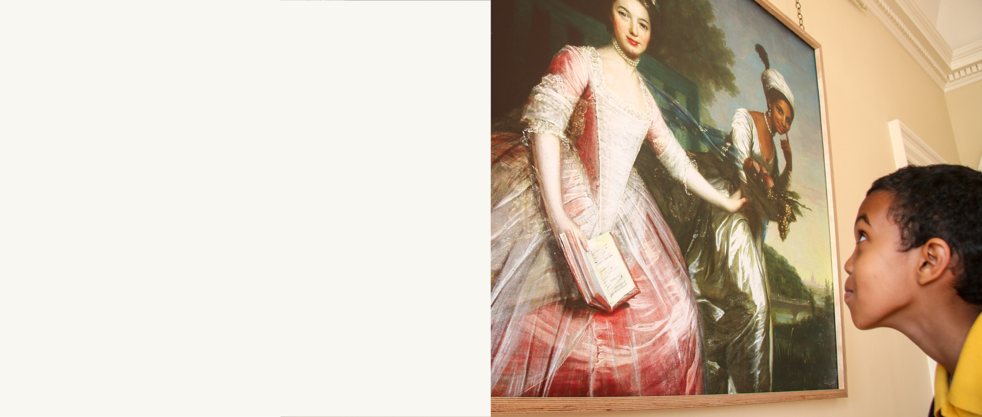A young boy studies a painting of Dido Belle at Kenwood in London