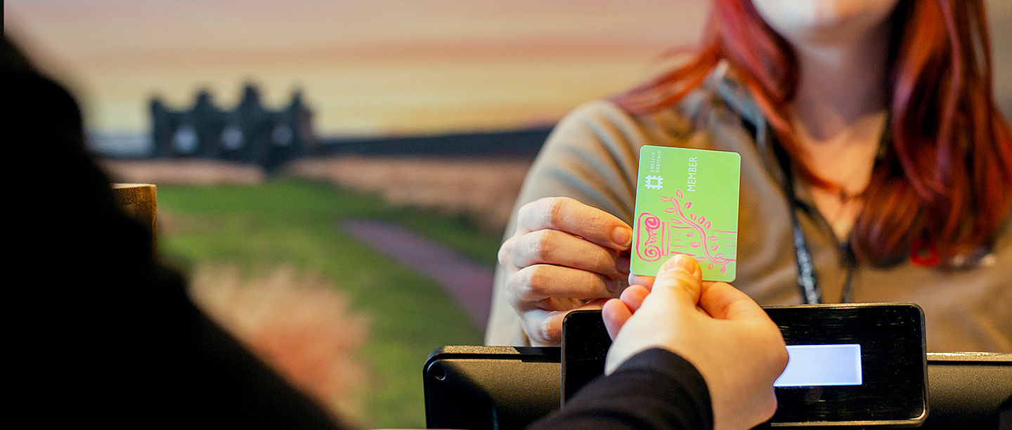 Image: Member handing membership card to staff member