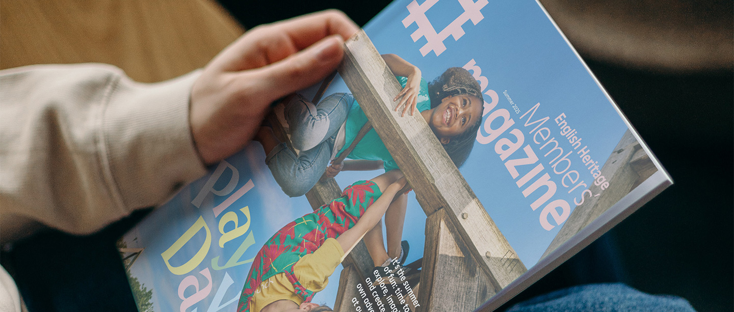 A person holds the English Heritage Members' Magazine in their hands