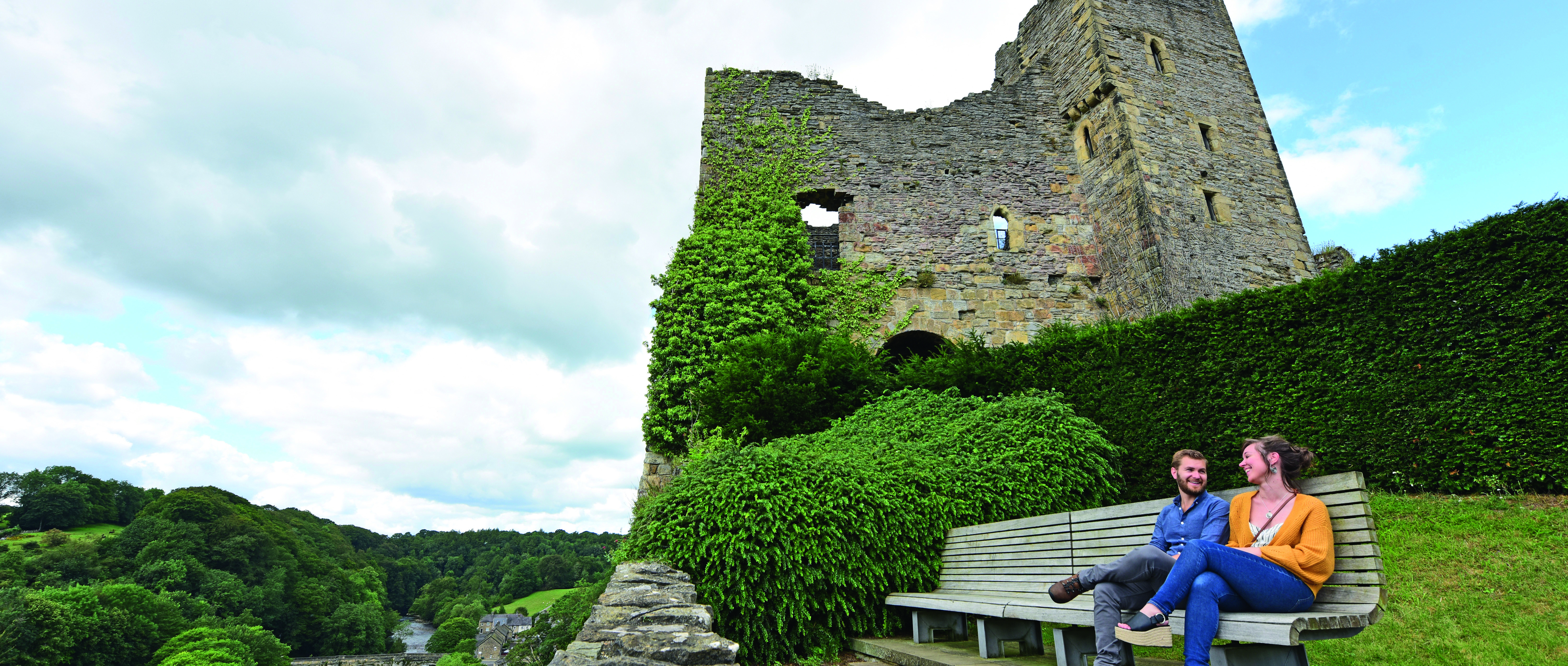 Image: Visitors sit outside a castle