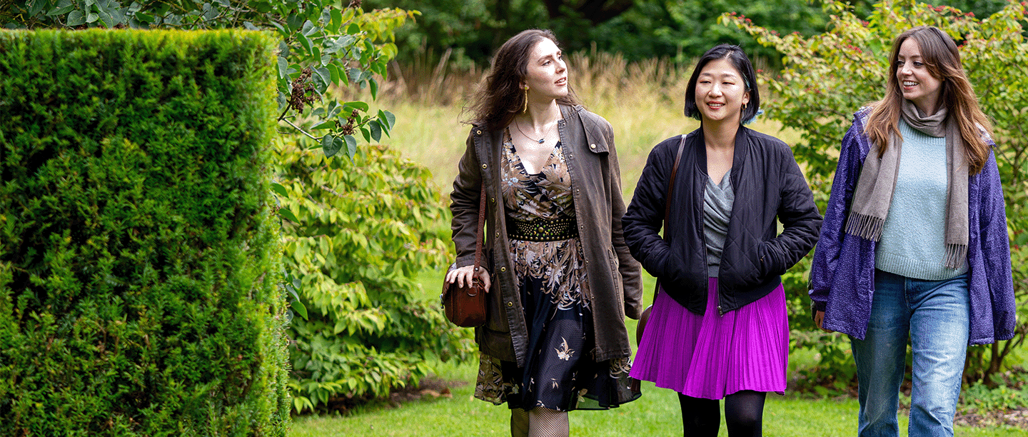 Photo of three young people walking through the gardens at Eltham Palace and Gardens in London