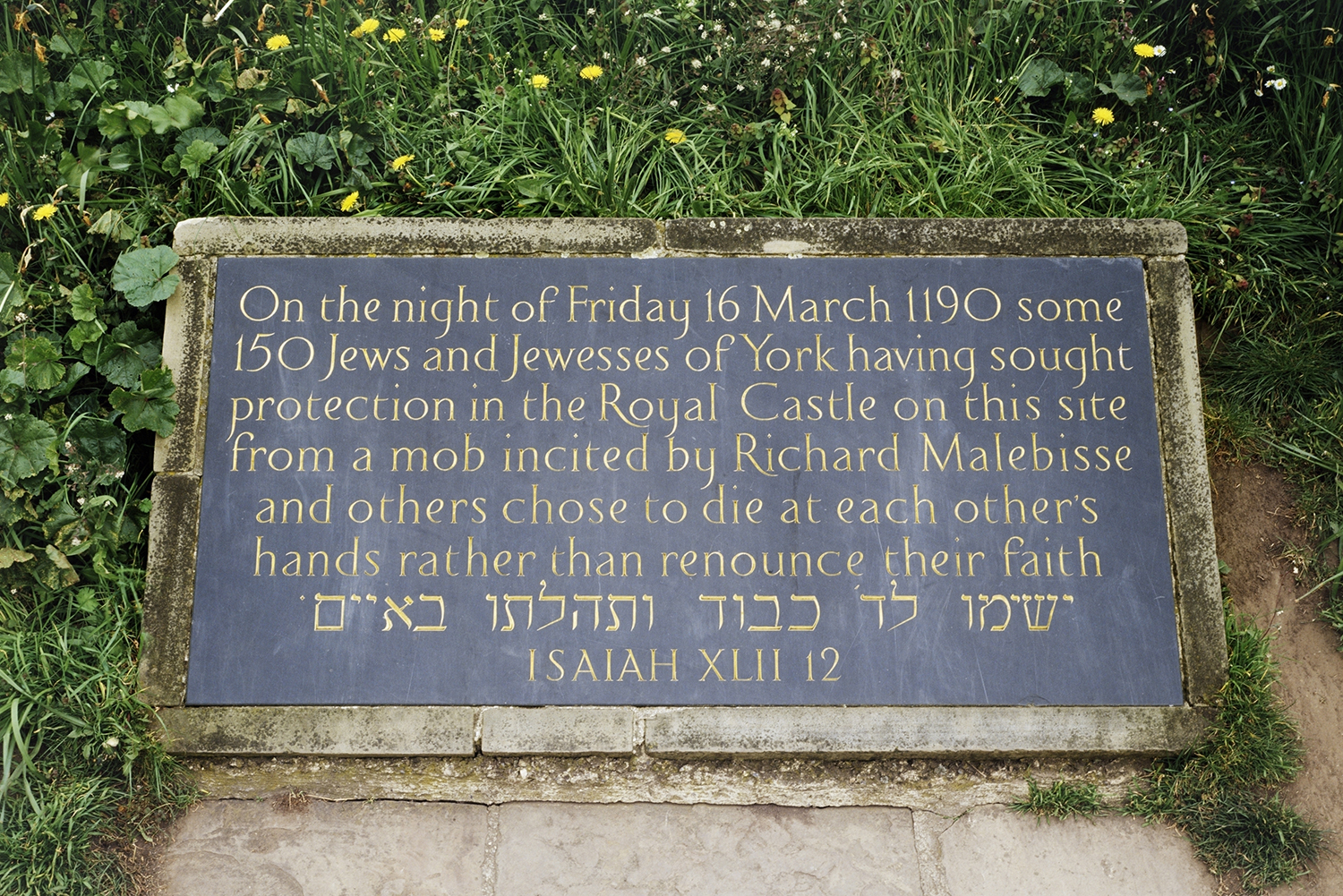 Commemorative plaque at the base of the mound of Clifford's Tower today