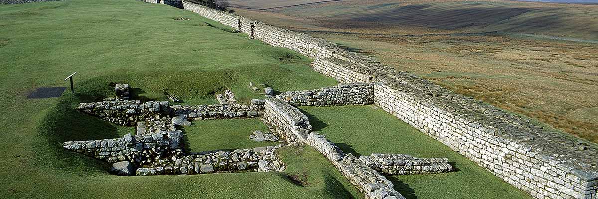 View along the north wall of Housesteads Fort, showing the foundations of turret 36b partially overlain by later walls