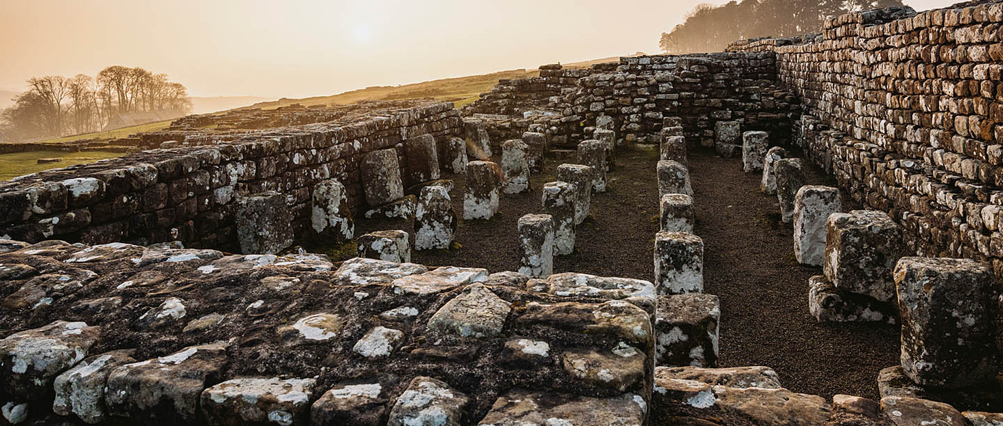 A dramatic sunrise on a misty morning at Housesteads Roman Fort