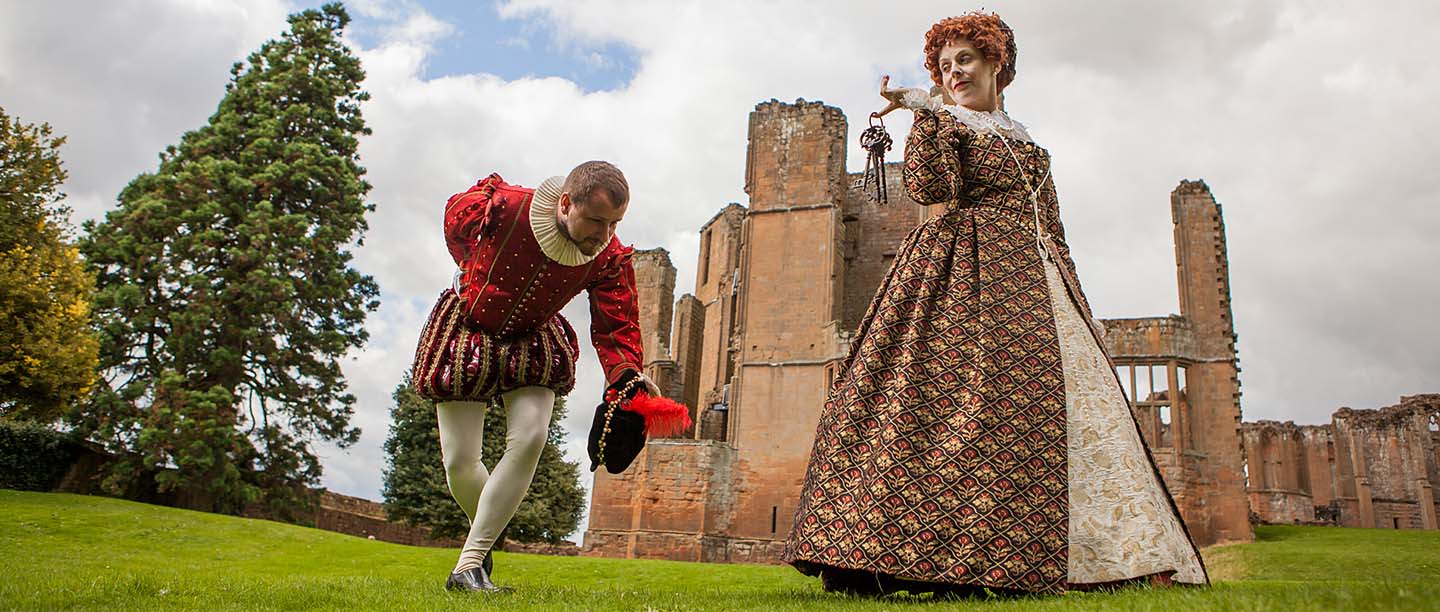Two costumed interpreters dressed up as Elizabeth I and Robert Dudley, in front of Kenilworth Castle