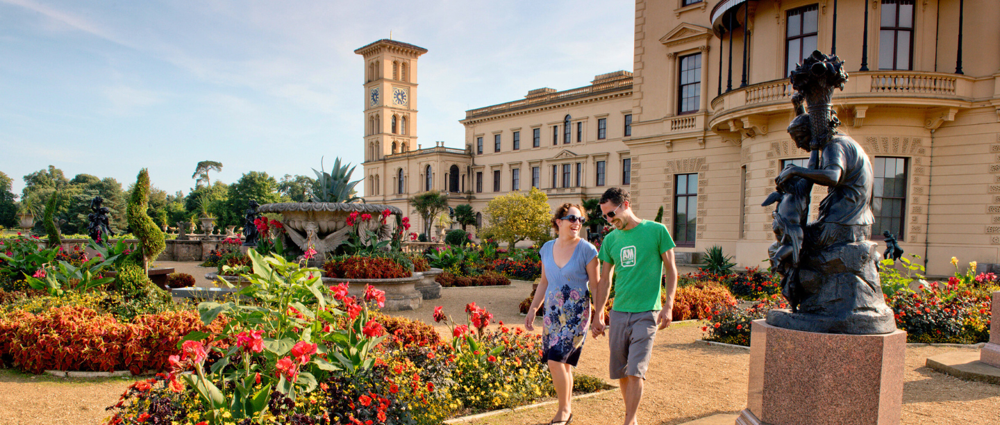 A couple explore the upper terrace garden at Osborne in summer time
