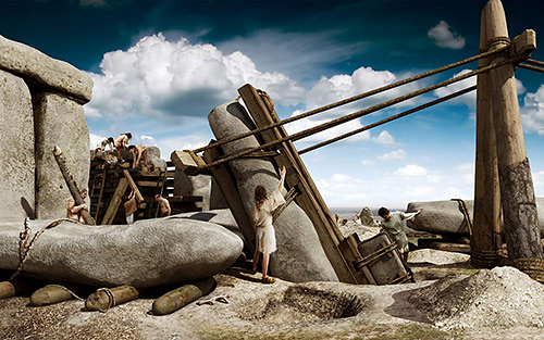 The huge stones of the sarsen circle being raised, about 2500 BC